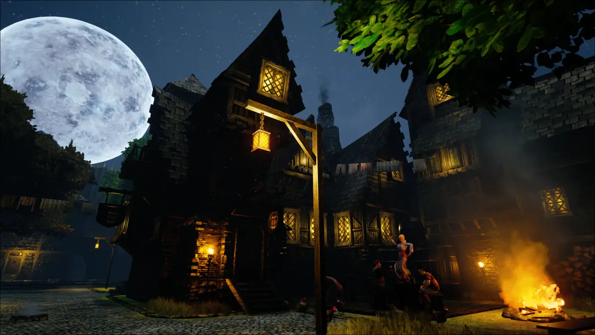 A dancer on a table beside a bonfire outside a timber-framed house with a hanging lantern under a full moon